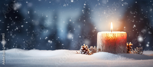 Christmas candle and snow as background