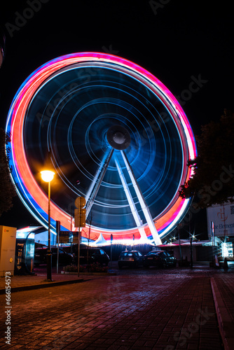 Ferris wheel with light trails. Kolobrzeg at night. Kołobrzeg is city in Poland. 