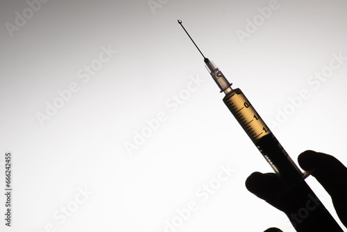 Closeup of drug injection in hand with text space