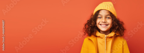 Portrait of happy kid smiling on bright colors studio background with empty copyspace, Cheerful little boy having fun