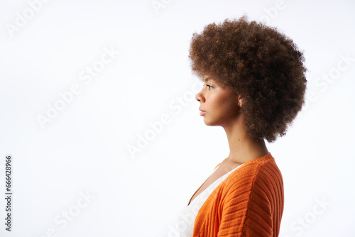 portrait of young latina woman with afro hair side view isolated on white background