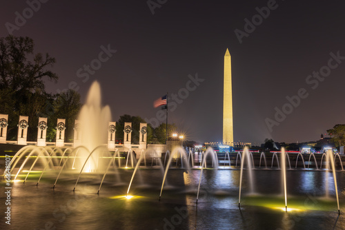 World War II Memorial at nighttime with the Washington Monument in the background in Washington DC, United States