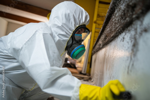 A professional technician in protective gear working to remove mold from a home. Generative Ai