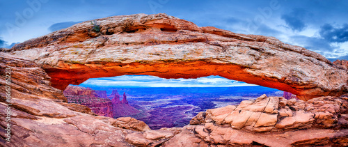 Mesa Arch with an incoming storm,.view to canyon and washerwoman Arch,Island in the Sky District.Canyonlands National Park, Utah, USA