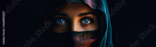 Horizontal banner. Close-up female portrait. Muslim tanned woman with blue eyes in burqa looks at camera. Concept of faith, god, arab world, palestine, islam. Head. Black background. Generative AI