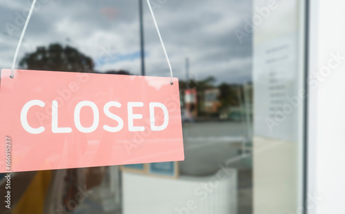 Closed sign on shop glass door. Auckland.