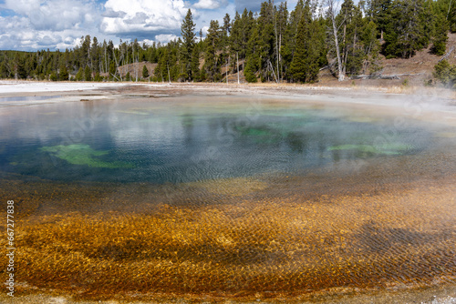Beauty pool with steam rising from it in Yellowstone National Park