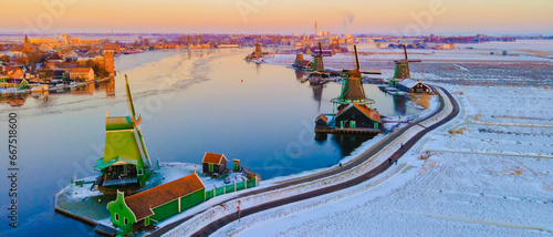Zaanse Schans Netherlands a Dutch windmill village during sunrise at winter with a snowy landscape, winter snow at the historical windmill village near Amsterdam