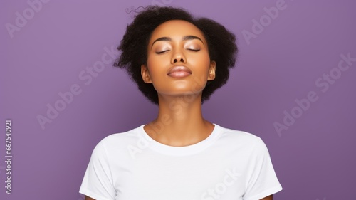 A fictional black woman with closed eyes and a white t-shirt. Isolated on a purple background.