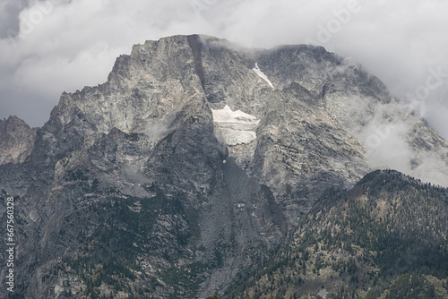 Mount Moran shrouded in clouds seen from the Cathedral Group Turnout in the Grand Teton National Park