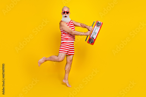 Full length photo of aged man gray bearded hurry up last chance buy tickets for summer ibiza nightclub isolated on yellow color background