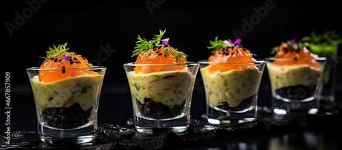Smoked salmon avocado and roe appetizers on a black table