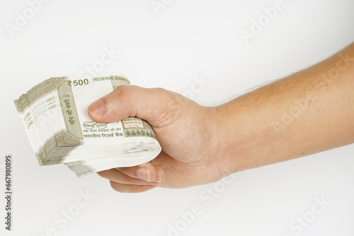 Bundle of indian rupees in hand on white background