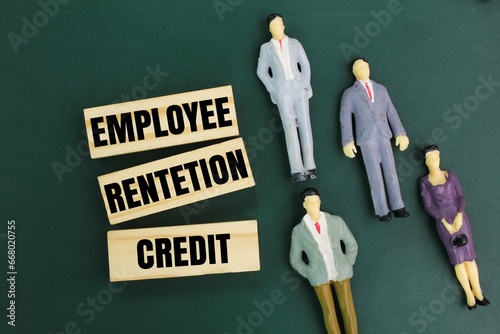 sticks and miniature people with the word Employee Retention Credit. the concept of employee salary retention