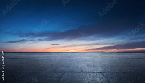 black asphalt floor background and dark blue night sky sunset horizon with subtle clouds