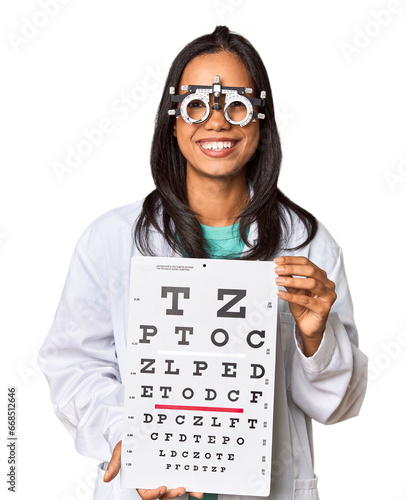 Young Filipina ophthalmologist holding optometry test chart
