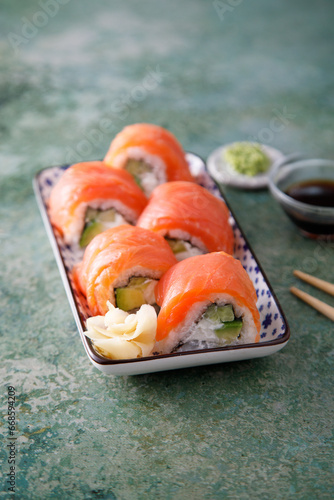 Salmon sushi rolls with cucumber and avocado