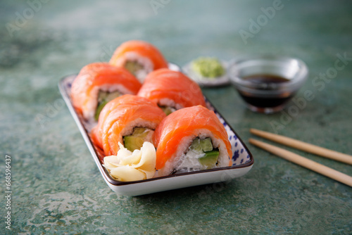 Salmon sushi rolls with cucumber and avocado
