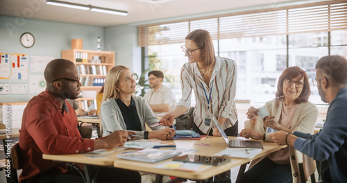 Diverse Group of Multiethnic Young and Senior Adults Finding a Solution to a Team Assignment, Undergoing Workforce Training Program for Improving Skills of Employees and Prospective Job Applicants.