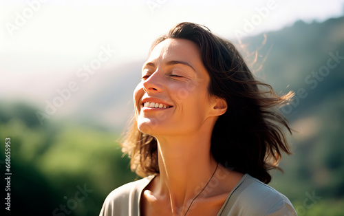 Middle-age woman breathing fresh air in the mountains.