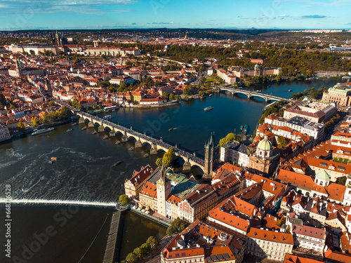 Scenic view of Prague Old town with crowded Carls Bridge, Vltava River, Hradčany Castle district on hilltop, Czech Republic
