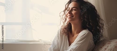 Smiling woman on bed looking elsewhere