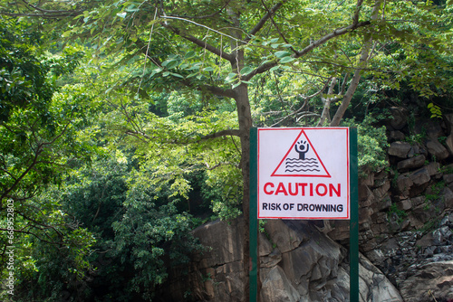 Caution board for risk of drowning at Aanaivaari Muttal Waterfalls located in Kalvarayan Hills near Attur, Salem district, India.