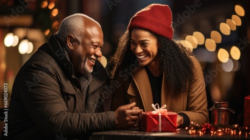  a couple of diverse senior presents each other with carefully chosen Christmas gift boxes, affirming their special bond