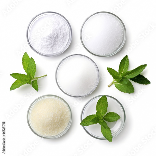 Set of different stevia sweeteners in powder, with leaves isolated separately on white background, top view