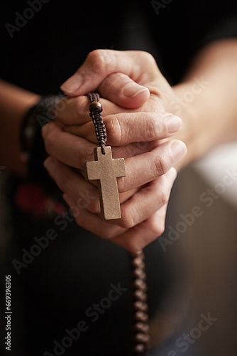 Hands, prayer with beads and worship for religion, trust and spiritual wellness with hope, peace and love. Support, mindfulness and person in Christian faith praying, gratitude and rosary with cross.