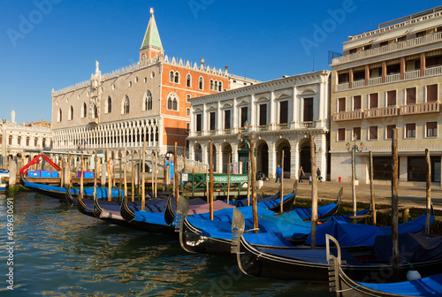 Gondolas boats and Doge palace at summer day, Venice, Italy