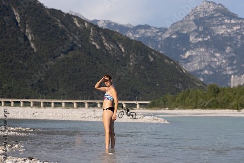 Adult Woman Cycled to the near River for a Refreshment in Summer - Carnia Italy