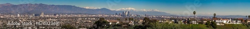 Los Angeles City Skyline with snow view from afar of Downtown with snowed mountains during winter