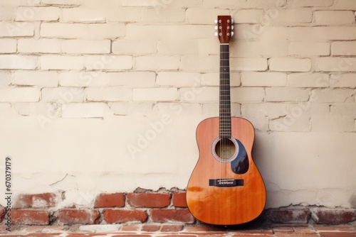 an acoustic guitar leaning against a wall