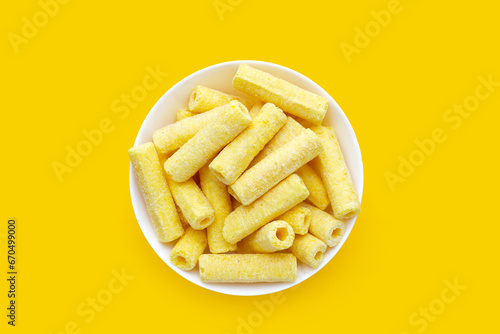 Roller corn snack on yellow background