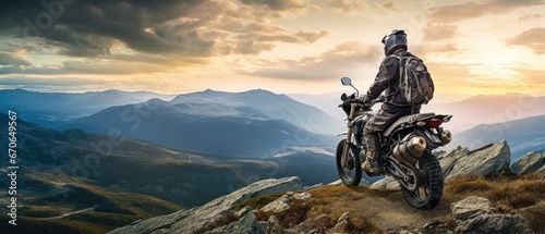 fearless biker perched at the edge of a rugged mountain cliff
