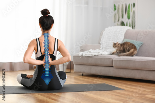 Young woman practicing yoga at home. Concept of healthy spine