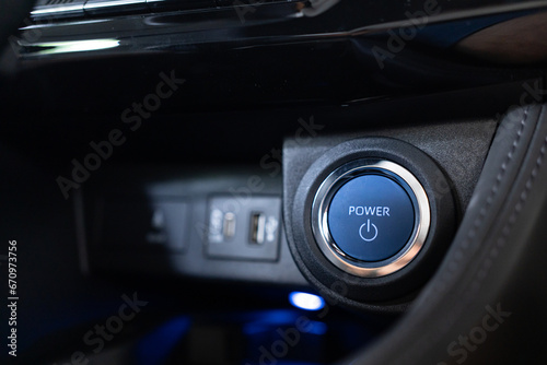 Blue power ignition button to start keyless ignition hybrid car engine Power button on a vehicle.