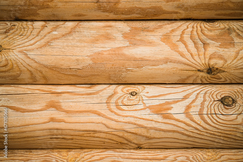 Natural background pattern of log wall. Construction of houses made of wood, rounded timber