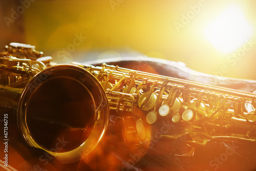 close up of a saxophone in open case on table against widow light effected, copy space for music decoration or poster background