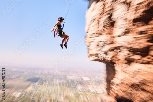 Sports, rock climbing and jump with woman on mountain for fitness, adventure and challenge. Fearless, workout and hiking with person training on cliff for travel, freedom and exercise mockup