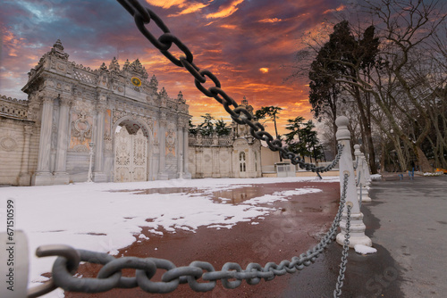 Sunset shot of closed gate leading former Ottoman Dolmabahce Palace, suited Ciragan Street, Besiktas distric. Gate contains monogram of Sultan Abd lmecid Underneath is a poem by Ziver dated 1855