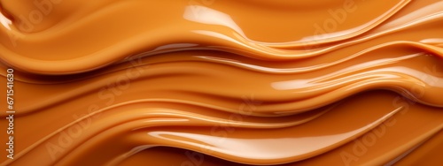 Liquid salted caramel syrup. Background of caramel paste. Texture Close up, top view.