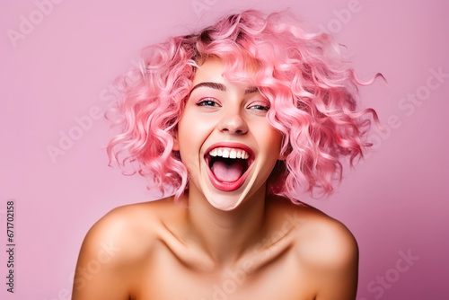 Joyful, nude woman with pink hair in colorful setting.