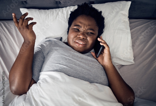 Confused, above and a black woman on a phone call in bed for communication, conversation or a chat. Frustrated, home and an African girl or person speaking on a mobile in the bedroom in the morning