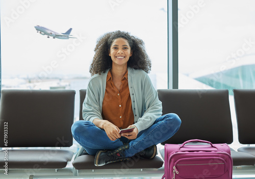Airport, black woman and portrait of a young person at flight terminal waiting for airplane travel. Passport document, smile and sitting solo female traveler feeling happy with freedom from adventure