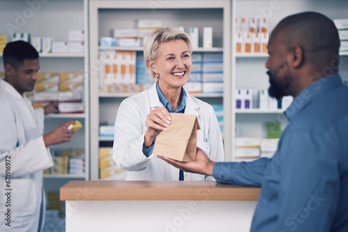 Happy woman, pharmacist and paper bag for patient, healthcare or medication at the pharmacy. Female person or medical professional giving pills, drugs or pharmaceuticals product to customer at clinic