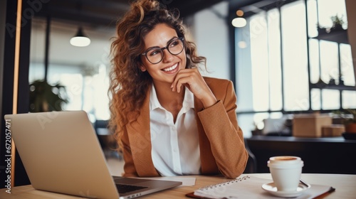 Professional female employee or a businesswoman using a laptop in a modern office. Copy space 