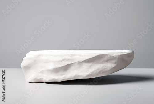 White stone podium on white table with gray wall background. High quality photo