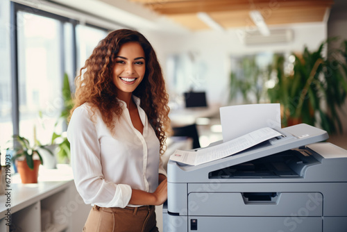 Office worker prints paper on multifunction laser printer. Document and paperwork concept. Secretary work. Smiling woman working in business office. Copy, print, scan, and fax machine.